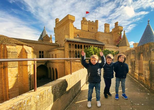 Three children in front of the Royal Palace of Olite